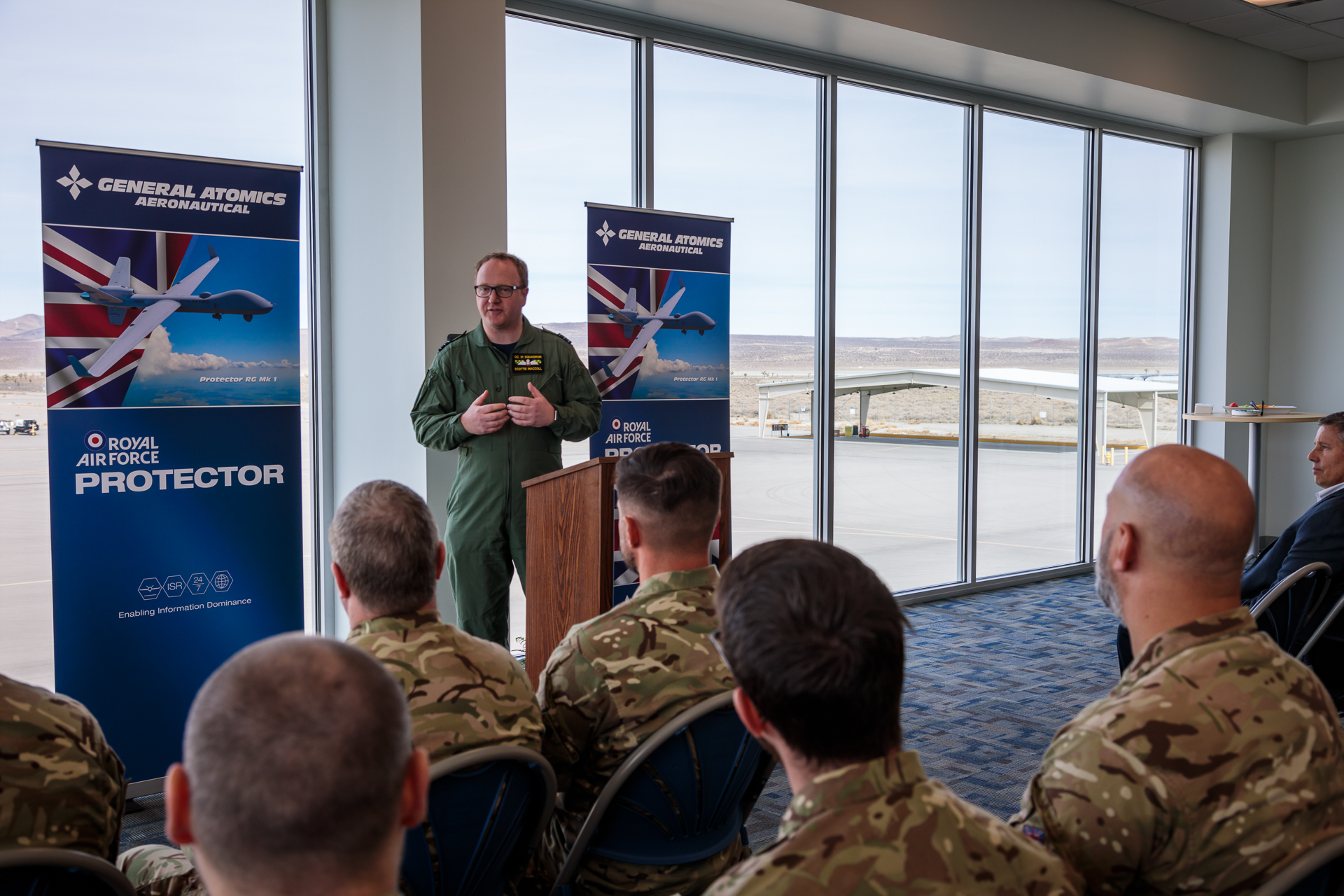 Image shows RAF aviators sitting in the audience of a presentation room before speaker.